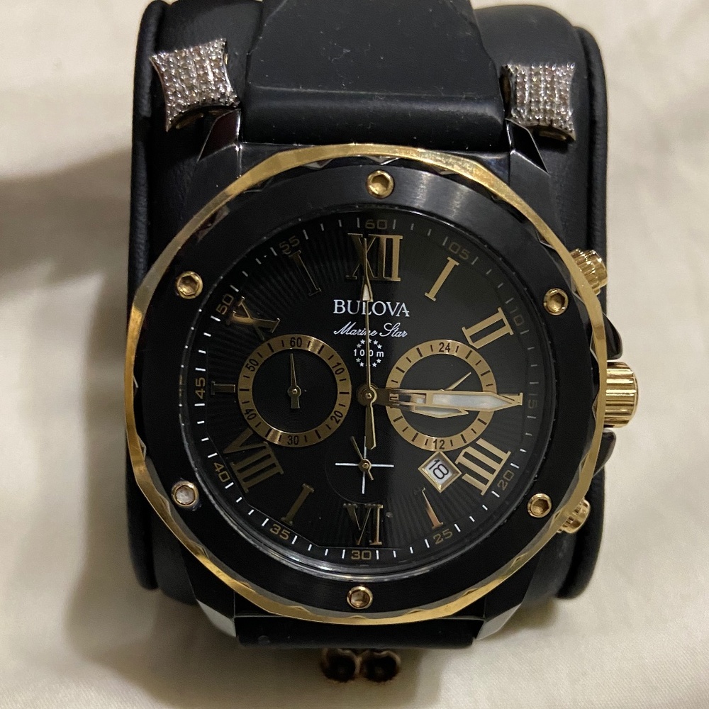 100 meter Bulova watch and 1/8 carat 10k gold earrings